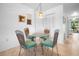 Small dinette area with glass table and wicker chairs at 8 Quails Run Blvd # 10, Englewood, FL 34223