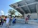 Outdoor community stage with people dancing and a musician playing at 8 Quails Run Blvd # 10, Englewood, FL 34223