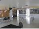 Community room with tables, chairs, and extensive book shelving at 8 Quails Run Blvd # 10, Englewood, FL 34223