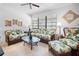 Living room with rattan sofas and a coffee table at 8 Quails Run Blvd # 10, Englewood, FL 34223
