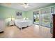 Bright bedroom with tiled floors and sliding glass doors leading to a balcony at 8 Quails Run Blvd # 10, Englewood, FL 34223