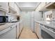 Efficient kitchen with white cabinets and appliances at 8 Quails Run Blvd # 10, Englewood, FL 34223