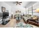 Living room featuring rattan furniture and a ceiling fan at 8 Quails Run Blvd # 10, Englewood, FL 34223