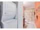 Bathroom with stackable washer/dryer, shower/tub combo, and granite vanity at 8413 Placida Rd # 407, Placida, FL 33946