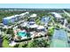 Aerial view of community pool, tennis courts and building at 8413 Placida Rd # 407, Placida, FL 33946