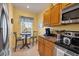 Bright kitchen nook with breakfast table, stainless steel appliances, and wood cabinets at 8413 Placida Rd # 407, Placida, FL 33946