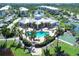 Community pool, tennis, and basketball courts with pond at 8413 Placida Rd # 407, Placida, FL 33946