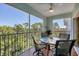 Relaxing screened lanai with outdoor furniture and tranquil wooded views at 8413 Placida Rd # 407, Placida, FL 33946