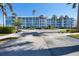Three-story light-blue condo building with parking area at 8413 Placida Rd # 407, Placida, FL 33946