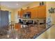 Kitchen boasts granite countertops, stainless steel appliances, and wood cabinets at 8413 Placida Rd # 407, Placida, FL 33946