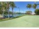 Well-maintained pickleball and tennis courts surrounded by palm trees at 8413 Placida Rd # 407, Placida, FL 33946