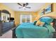 King-size bed, ceiling fan, and large windows in this bright bedroom at 8413 Placida Rd # 407, Placida, FL 33946