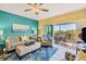 Relaxing living room with comfortable seating, blue accent rug, and ceiling fan at 8413 Placida Rd # 407, Placida, FL 33946