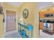 Condo entryway with wood door and teal console table at 8413 Placida Rd # 407, Placida, FL 33946