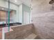 Modern bathroom with a walk-in shower, double vanity, and dark countertops at 8374 Agate St, Port Charlotte, FL 33981