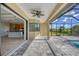 Spacious enclosed patio with pool access, tile flooring, and ceiling fan at 8374 Agate St, Port Charlotte, FL 33981