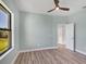 Bright bedroom with light walls, wood-look flooring, and a ceiling fan at 8374 Agate St, Port Charlotte, FL 33981