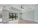 Main bedroom with pool access and tray ceiling at 8374 Agate St, Port Charlotte, FL 33981
