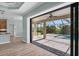 Open living area showcasing a view of the pool and patio through sliding glass doors at 8374 Agate St, Port Charlotte, FL 33981
