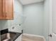 Laundry room with sink, cabinets, and wire shelving at 8374 Agate St, Port Charlotte, FL 33981