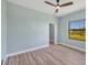 Spacious bedroom with light walls, wood-look flooring, and a ceiling fan at 8374 Agate St, Port Charlotte, FL 33981