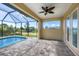Enclosed patio with pool access, tile flooring, and sliding doors at 8374 Agate St, Port Charlotte, FL 33981