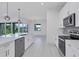 Open concept kitchen with island and view into the dining area at 15715 Viscount Cir, Port Charlotte, FL 33981