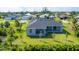 Aerial view of the house, showing the backyard, landscaping, and neighborhood at 15715 Viscount Cir, Port Charlotte, FL 33981