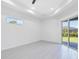 Spacious bedroom with large window and sliding glass doors at 15715 Viscount Cir, Port Charlotte, FL 33981