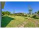 Landscaped backyard with young trees and a grassy lawn at 15715 Viscount Cir, Port Charlotte, FL 33981