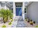 Front entrance with blue double doors and landscaping at 15715 Viscount Cir, Port Charlotte, FL 33981