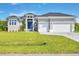 Single-story home with a two-car garage at 15715 Viscount Cir, Port Charlotte, FL 33981