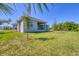 View of house from backyard showcasing the covered patio at 15715 Viscount Cir, Port Charlotte, FL 33981