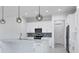 Clean kitchen with white cabinets, stainless steel appliances, and quartz countertops at 15715 Viscount Cir, Port Charlotte, FL 33981