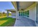 Spacious covered patio with tile flooring, extending from the house into the backyard at 15715 Viscount Cir, Port Charlotte, FL 33981