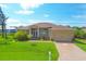 Single-Gathering house with a manicured lawn and attached garage at 249 Rotonda Cir, Rotonda West, FL 33947