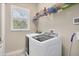 Laundry room with washer, dryer, and overhead shelving at 249 Rotonda Cir, Rotonda West, FL 33947