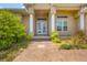 Inviting front entrance with double doors and landscaped walkway at 249 Rotonda Cir, Rotonda West, FL 33947