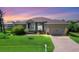 Single-Gathering home with landscaped lawn and attached garage at 249 Rotonda Cir, Rotonda West, FL 33947