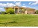 Single Gathering home with lush landscaping and attached garage at 249 Rotonda Cir, Rotonda West, FL 33947