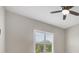 Well-lit bedroom featuring plantation shutters and a ceiling fan at 249 Rotonda Cir, Rotonda West, FL 33947