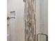 Walk-in shower with mosaic tile and built-in shelving at 249 Rotonda Cir, Rotonda West, FL 33947