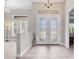 Bright and airy entryway with double doors and tile flooring at 249 Rotonda Cir, Rotonda West, FL 33947