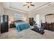 Spacious bedroom with ceiling fan and teal bedding, offering a relaxing atmosphere at 249 Rotonda Cir, Rotonda West, FL 33947