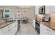 Spacious kitchen with granite countertops, stainless steel appliances, and white cabinetry at 249 Rotonda Cir, Rotonda West, FL 33947