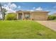 Single-Gathering home with landscaped lawn and attached garage at 249 Rotonda Cir, Rotonda West, FL 33947