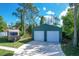 Spacious two-car detached garage with white roll-up doors at 7168 Lighthouse St, Englewood, FL 34224