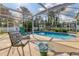 Relaxing pool area with covered patio and comfortable seating at 7168 Lighthouse St, Englewood, FL 34224