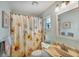 Guest bathroom with shower/tub combo and sunflower shower curtain at 7168 Lighthouse St, Englewood, FL 34224