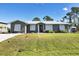 Charming single story home with green exterior and lush lawn at 7168 Lighthouse St, Englewood, FL 34224